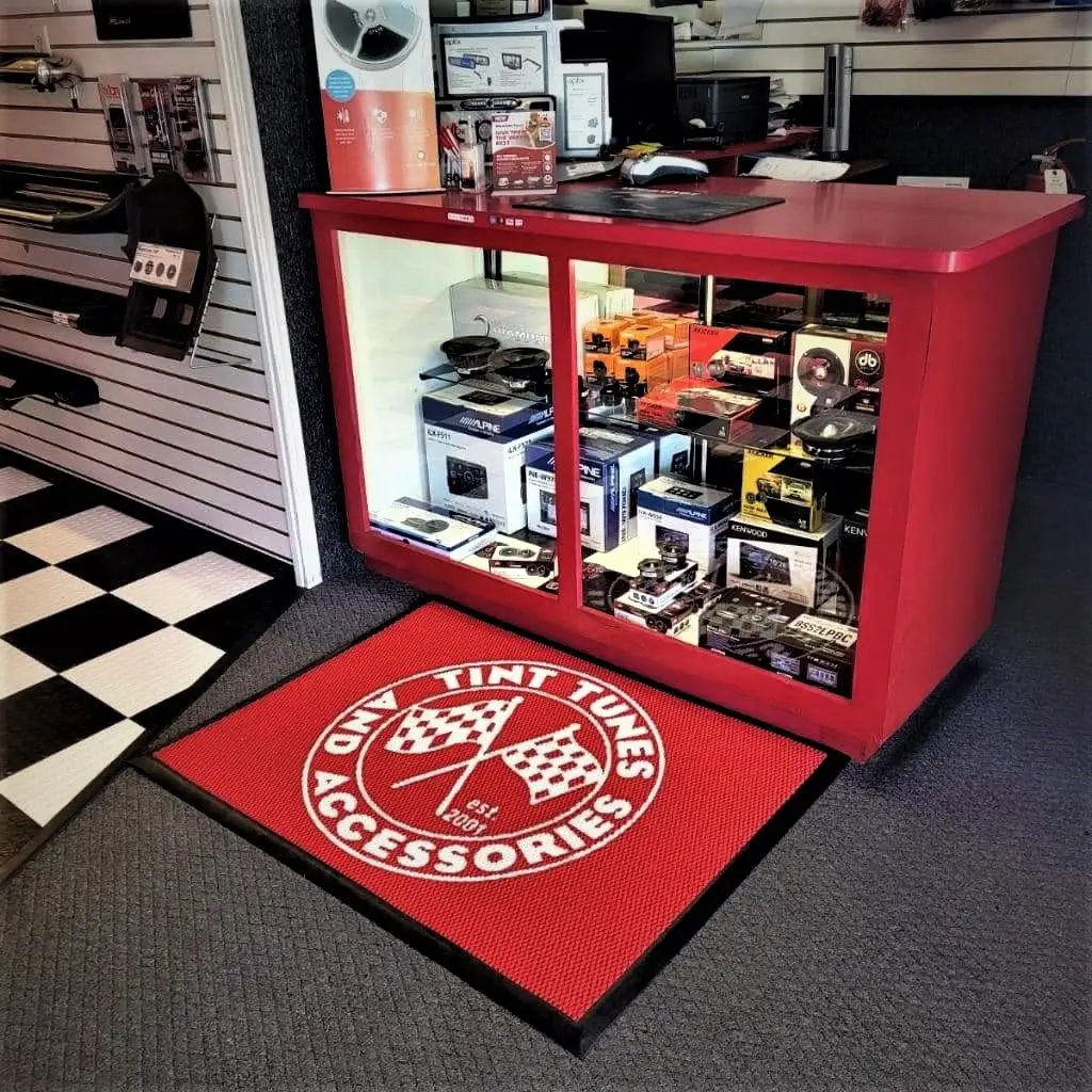 A red cabinet with a rug on the floor