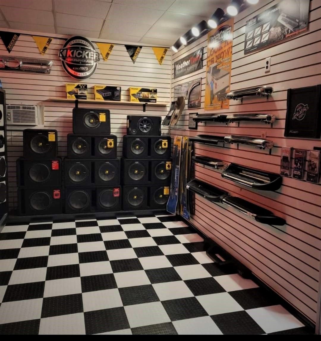 A room filled with speakers and a wall of music.